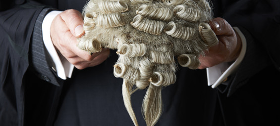 Barrister holding wig